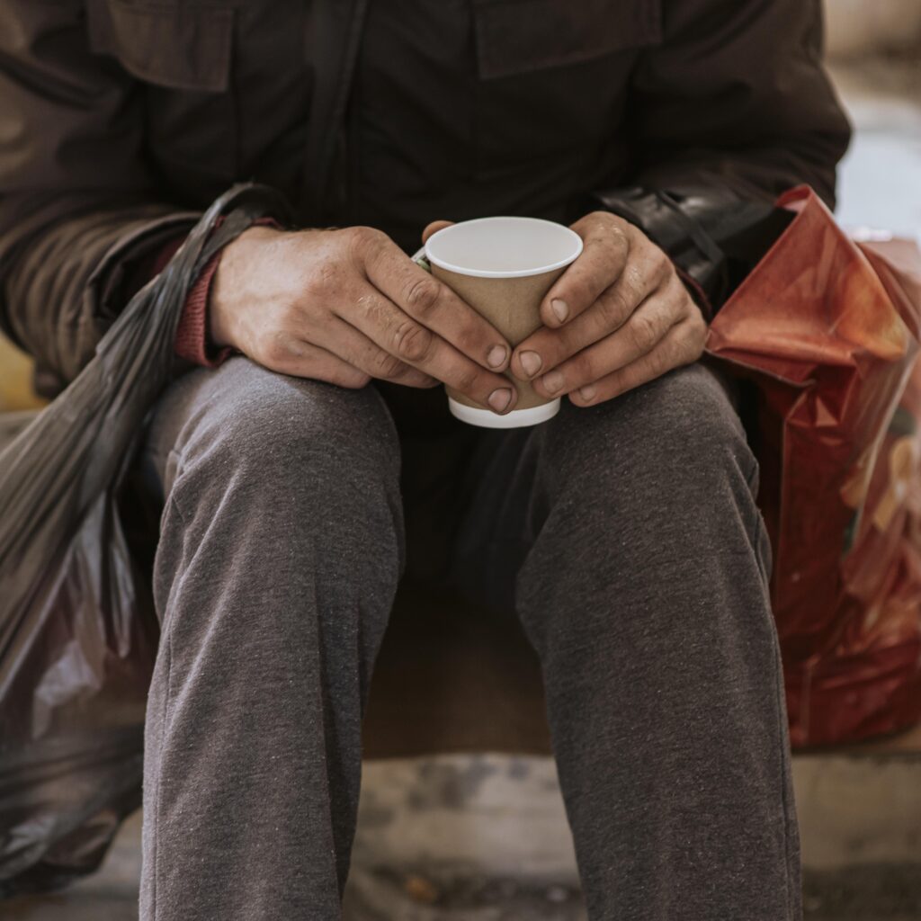 front view homeless man holding cup plastic bag front view homeless man holding cup plastic bag